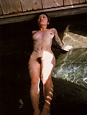 Megumi Osawa relaxes in the nude in a hot spring bath