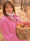 Smiling Miko Hayama picking apples